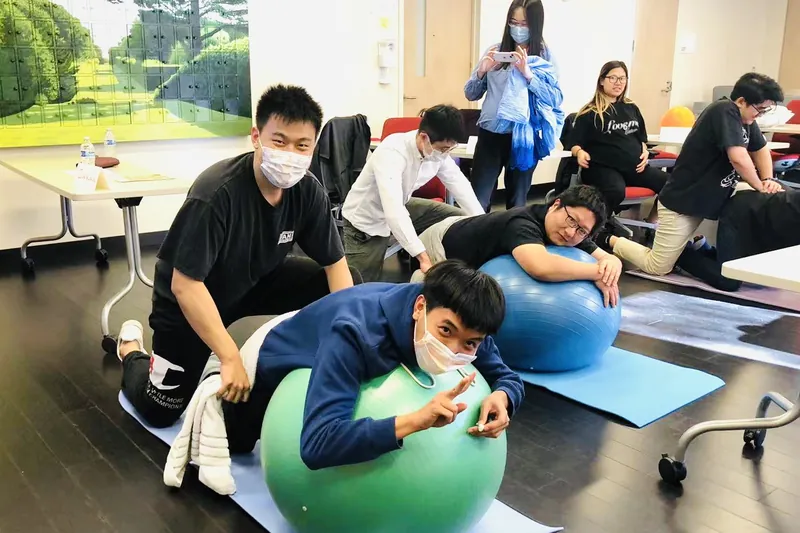Couples practicing on birth balls in class