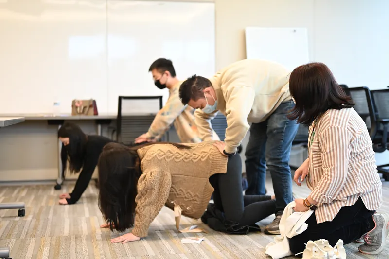 Partners practicing hands-and-knees positions